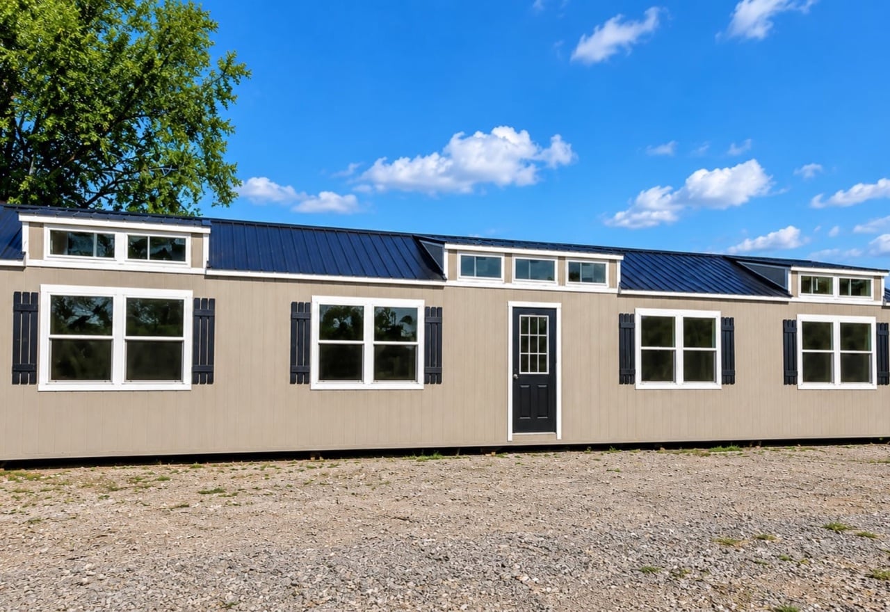 16x60 lofted cabin with dormers and black shutters
